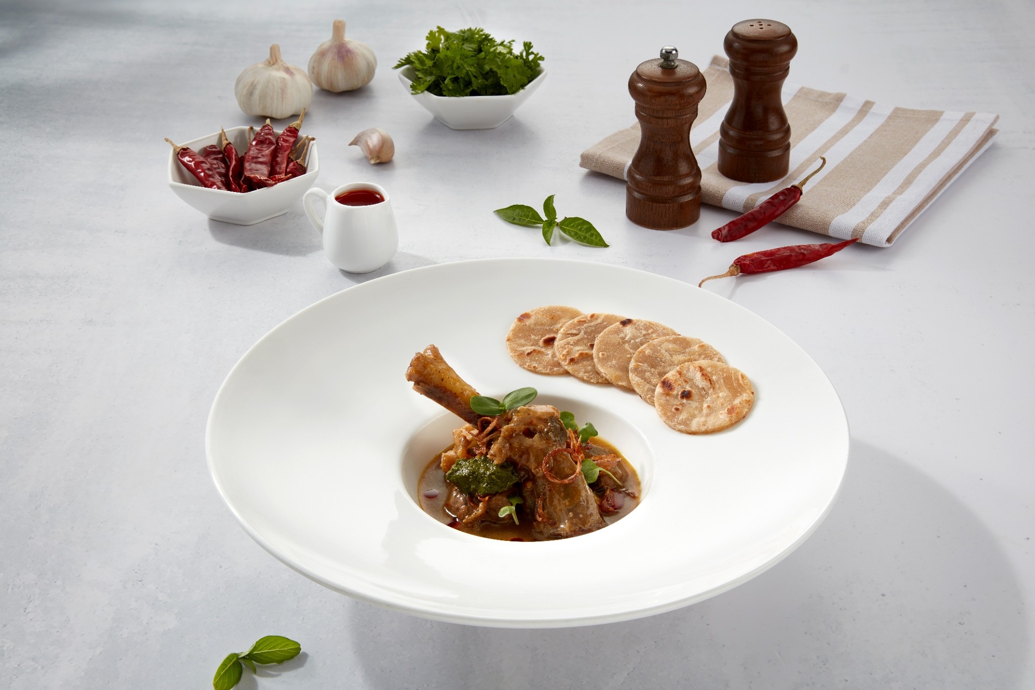 Koji-Marinated Lamb Shank Uppu Kari with Miso, Coin Parotta & Curry Leaf Pesto